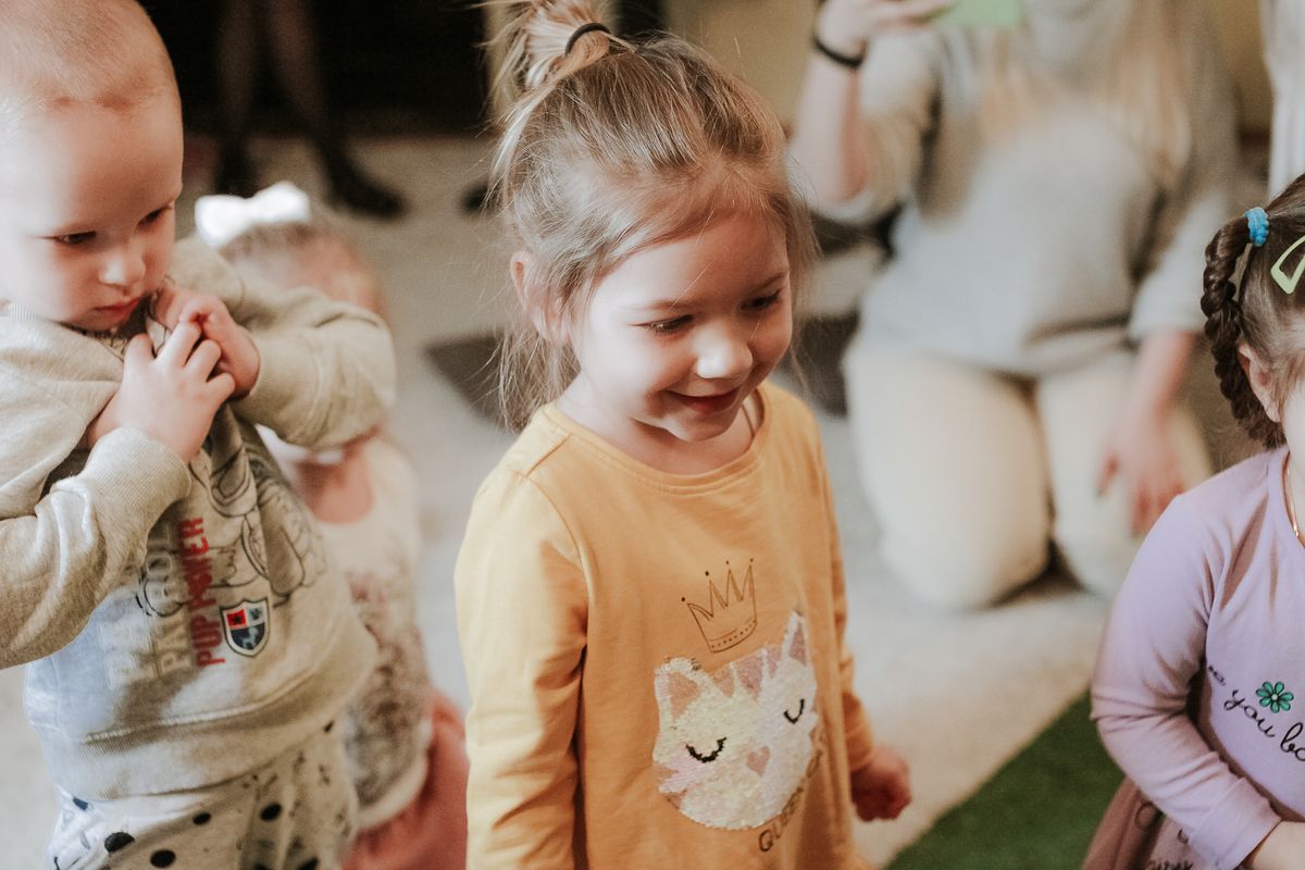 Children playing happily with the support of a caring adult