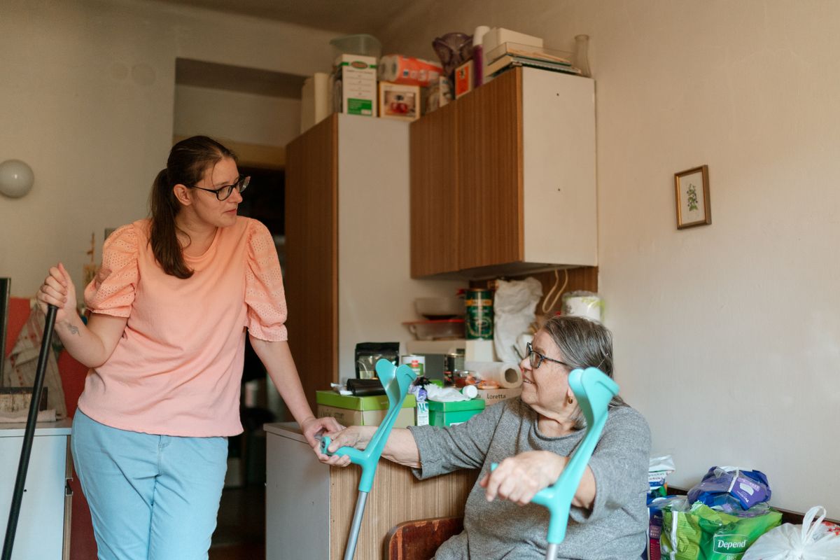 A support professional helping an individual with everyday tasks at home