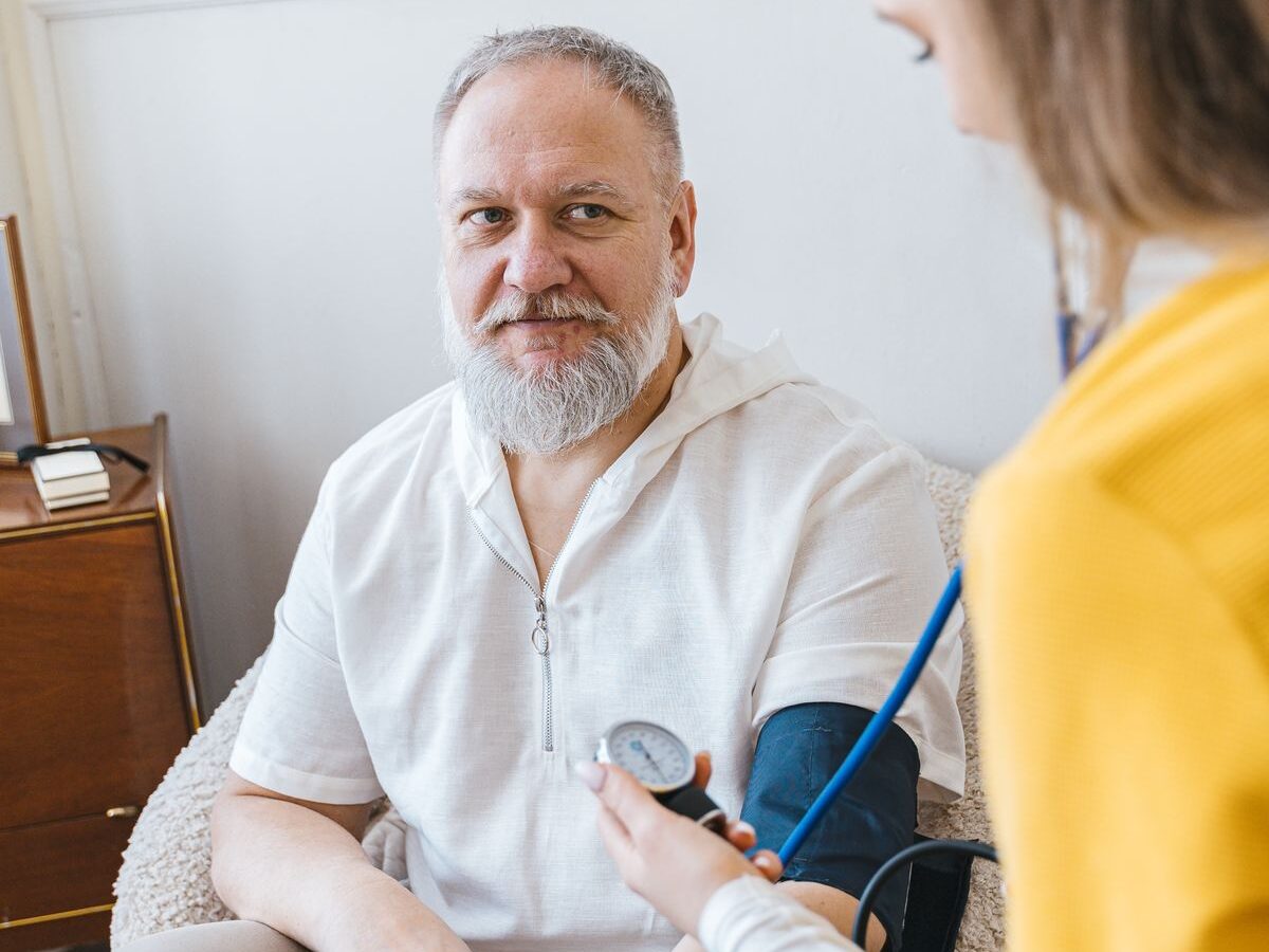 A nurse checking on a patient during a home visit