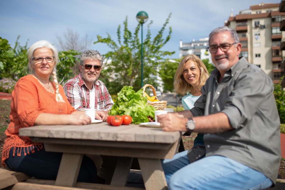 A group of older adults enjoying a social gathering outdoors
