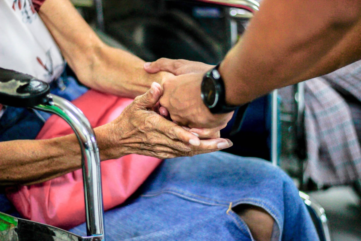 A personal support worker helping an older adult with everyday support at home