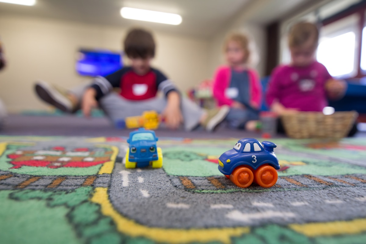 Young children playing and learning together in a bright space