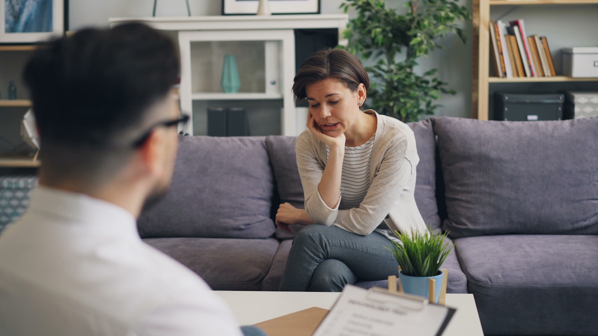 A companion sharing a warm conversation with someone at home